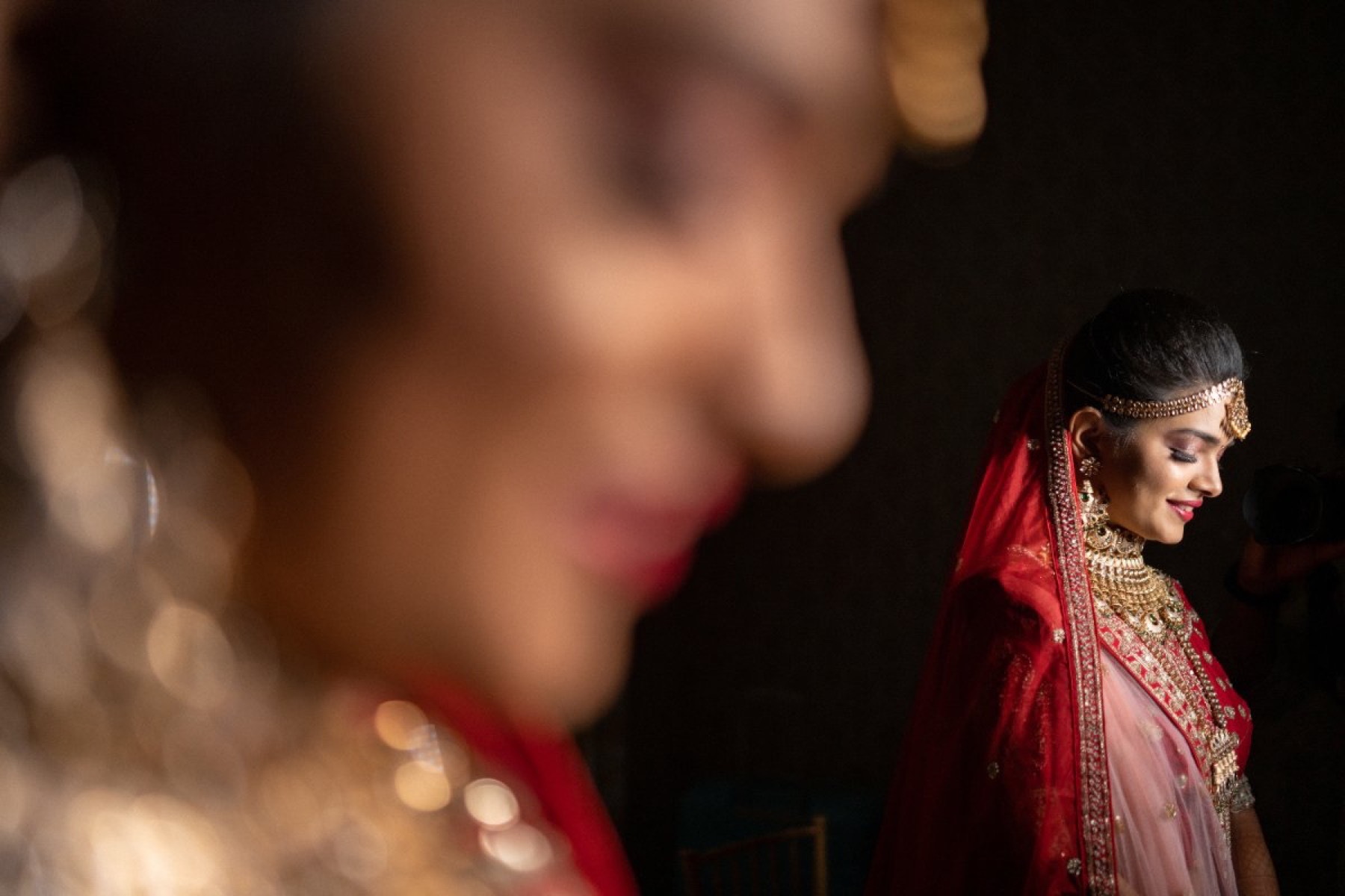 Indian bride in a red saree during the ceremony, photographed by WeddingClickz