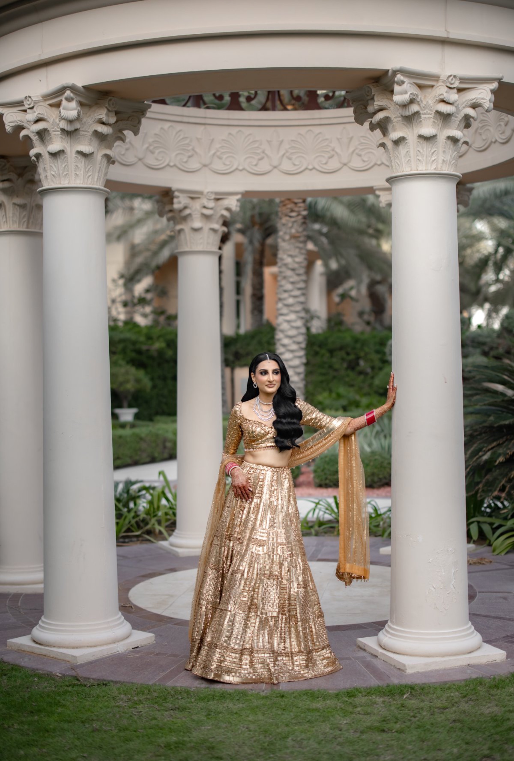 Indian bridal portrait in a gold lehenga by WeddingClickz