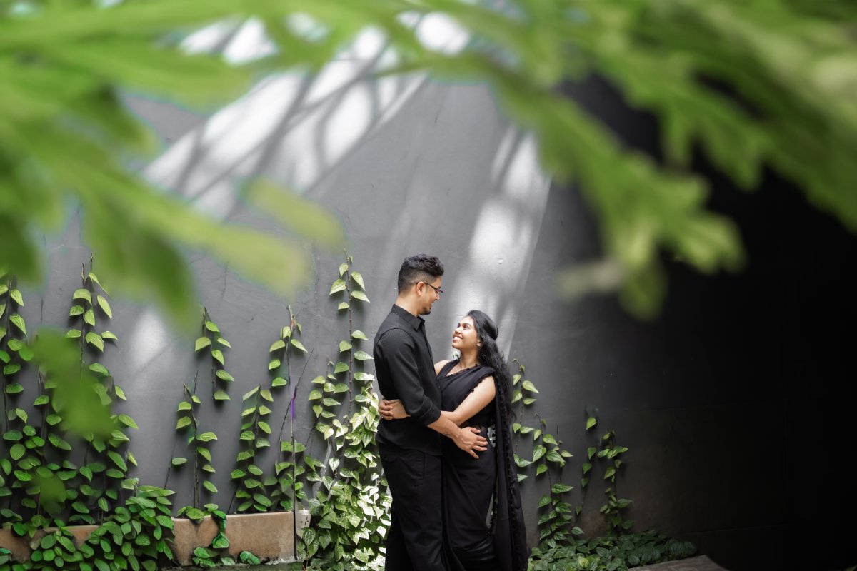Pre-wedding couple shoot by WeddingClickz — shade, greenery and a clean wall