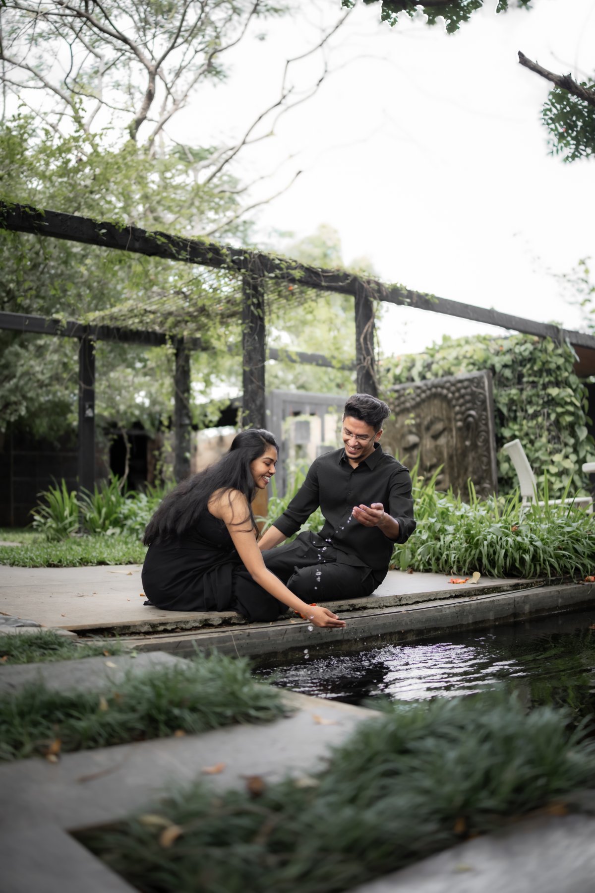 Pre-wedding couple shoot by WeddingClickz — sitting, talking, barely aware of the camera