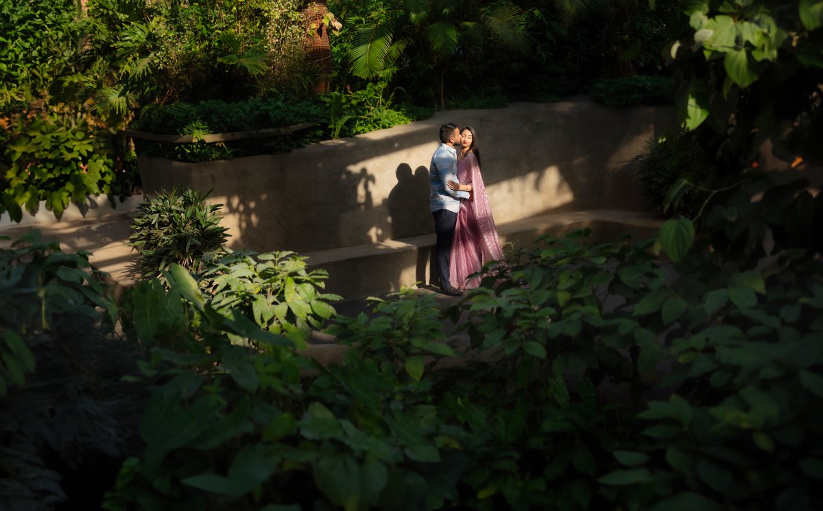 Pre-wedding couple shoot by WeddingClickz — green steps, shot from distance
